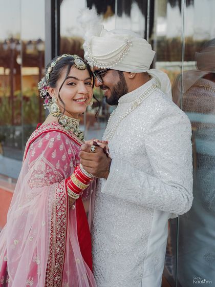 The bride looks directly at the camera while the groom looks at her, creating a lovely connection with the viewer.