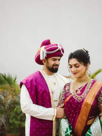 A gentle and romantic portrait of the groom looking at his bride, showcasing their traditional attire against a soft, natural background.
