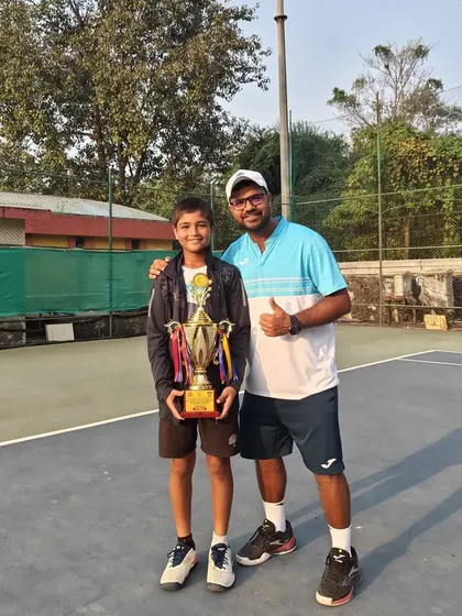Another shot of Aarav and his coach celebrating the National Series doubles victory. The coach-player bond is crucial for success.