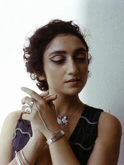 A portrait of artist Sanjeeta Bhattacharya for the album art, with a focus on dramatic makeup and statement silver jewelry.