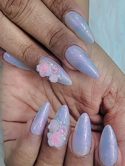 We love adding texture and dimension with 3D nail art. This set features long, iridescent stiletto nails with intricate, hand-sculpted pink roses and beadwork, creating a beautiful and tactile finish.