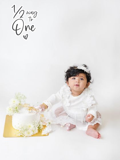 Halfway to one and already smashing cake. This six-month milestone is a perfect opportunity for a mini cake smash to capture their delight.