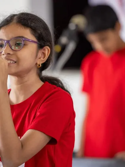 A young vocalist confidently takes the microphone during our community performance. We focus on building stage presence from an early age, helping even our youngest students shine.