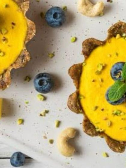 These beautiful mango tarts are a perfect summer dessert. A crisp tart shell is filled with creamy mango custard and topped with fresh blueberries and mint.