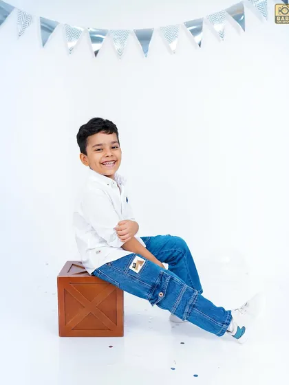 Turning five in style. This young man has a cool and confident pose for his birthday photoshoot.