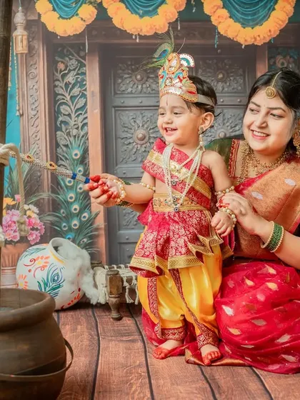 Mother and son playing near the 'makhan' pot, a classic scene from the stories of Krishna.