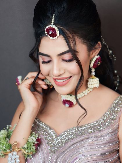 A beautiful shot of the model with her eyes closed, showing off the soft pink eyeshadow. This look is perfect for a sangeet or mehendi ceremony.