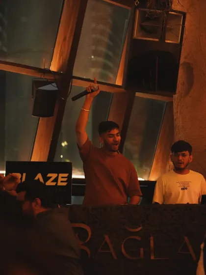 This is me in my element at Baglami, Mumbai. I don't just play music; I perform and engage with the crowd, using the microphone to hype everyone up and ensure the party never stops.