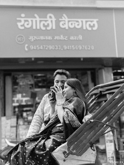 A candid black and white shot of a couple on a rickshaw in Varanasi, capturing the authentic spirit of the city.