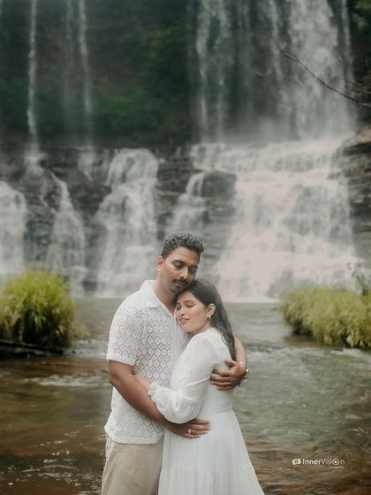 A peaceful embrace in front of the cascading water. The couple holds each other close, their serene expressions reflecting the tranquility of the natural surroundings.