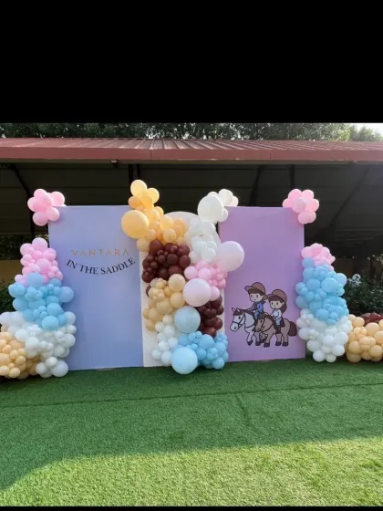 A special horse-themed celebration for a child's 'first saddle' event at Vantara, featuring a custom backdrop and a colorful balloon arrangement.