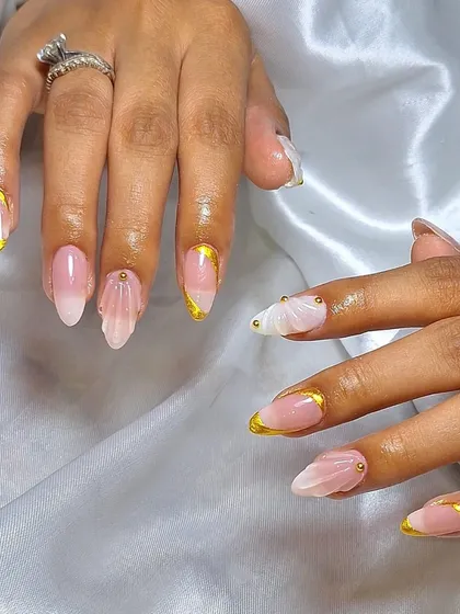 A beautiful ombre shell nail design with a delicate gold French tip. This combines multiple techniques for a truly unique and luxurious manicure.