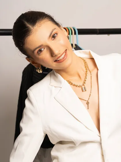 A softer, more approachable expression from the same shoot. The natural-looking makeup enhances her features without being distracting, perfect for a professional branding photoshoot.