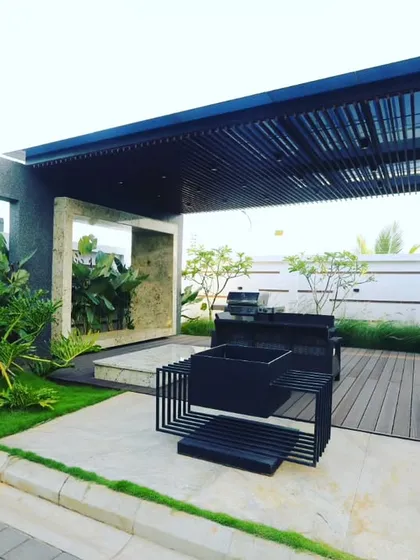 I design functional outdoor living areas like this modern pergola with an integrated barbecue station. It’s about creating a space for living, not just looking, combining hardscape elements with soft, natural plantings.