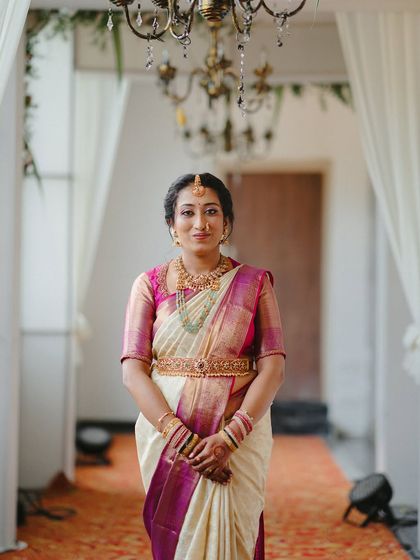 A full-length portrait of this beautiful bride, her subtle makeup look perfectly complementing her elegant saree.