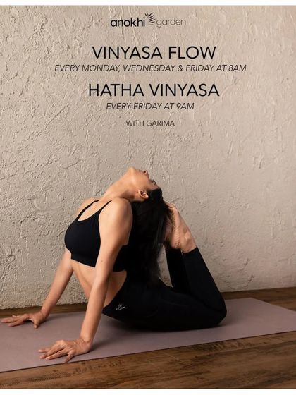 A student practices a deep backbend during a Vinyasa Flow class. Our classes with Garima focus on synchronizing breath with movement to build internal heat and improve flexibility.