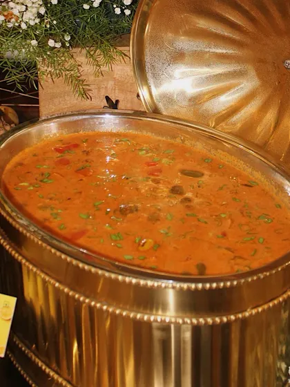 A close-up of a delicious Penang Curry in one of our signature chafing dishes. It's a comforting and flavourful main course, perfect for a tropical-themed party.