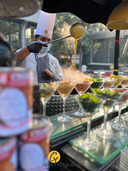 Our chef at the live Ouve Soup Counter, preparing customized bowls of hot, flavourful soup with a variety of fresh toppings for guests.