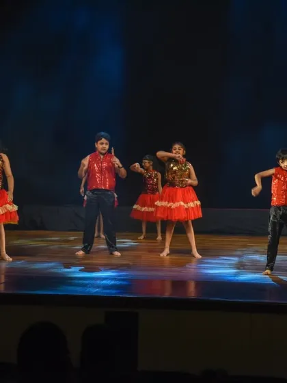 The kids strike a final pose in their Bollywood number. This image reflects a successful performance filled with energy, showcasing their confidence and stage presence.