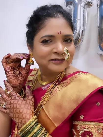 The mother of the groom, looking regal and beautiful in her traditional Marathi attire.