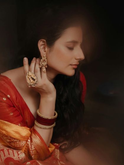 Draped in elegance and powered by confidence. A soft, dreamy portrait focusing on the model's serene profile and the intricate details of her jewelry.