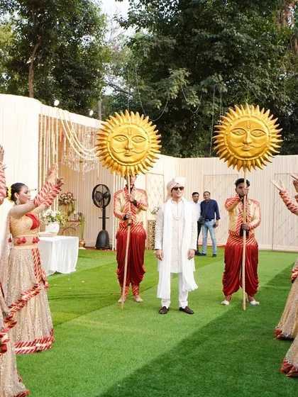 A wide shot showcasing the choreography of a groom's entry. My dancers create a symmetrical, welcoming formation as the groom stands poised to enter, highlighting the organized grandeur of the event.