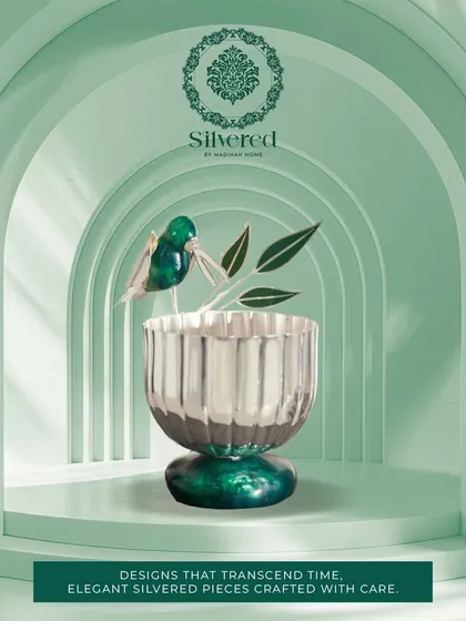 A silvered bowl with a malachite base and a hummingbird accent. This piece from our Silvered Collection is an example of elegant design that transcends time, crafted with care.