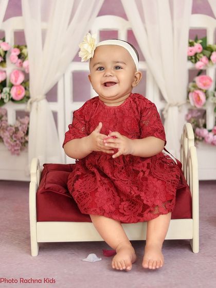 A happy, clapping pose from the red floral room shoot.