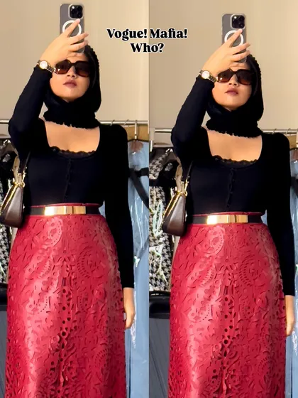 Vogue Mafia? Who? This look is all about power and drama. A black turtleneck top paired with a striking red laser-cut skirt and a headscarf creates a look that is bold, mysterious, and high-fashion.