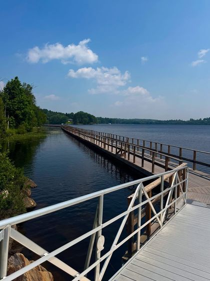 A scenic view of the long boardwalk over the water in Huntsville, Ontario. I capture landscapes to help tell a complete travel story.