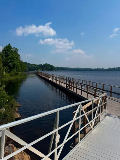 A scenic view of the long boardwalk over the water in Huntsville, Ontario. I capture landscapes to help tell a complete travel story.