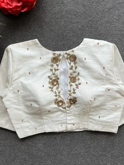 A full view of the back of the white handwork blouse.