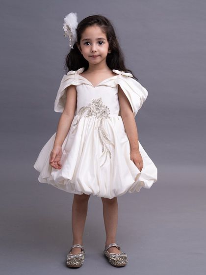 A sweet and simple white bubble dress with off shoulder details and a touch of embroidery.