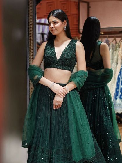 Dazzle in this bottle green sequin lehenga, where rich hues meet intricate embellishments.