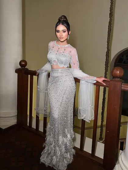 Presenting "Viraaya," a stunning silver-grey ensemble. I styled this with a sleek high bun and dramatic feather details for a modern, high-fashion look.