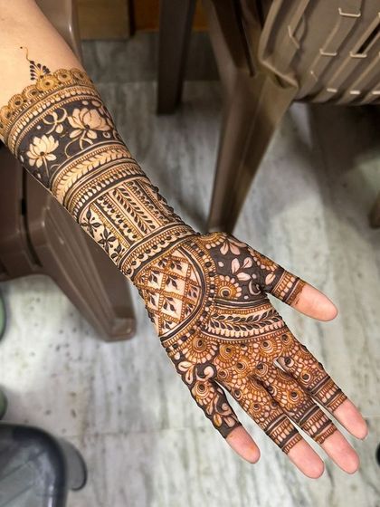 A classic Indian non-bridal design with a prominent lotus band on the forearm.