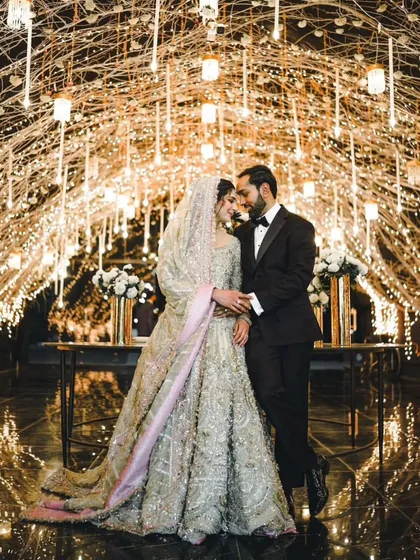 Under a canopy of twinkling fairy lights, I capture the quiet moments of connection. This reception shot shows the blend of luxury decor and genuine intimacy, creating a timeless portrait of the couple lost in their own world.