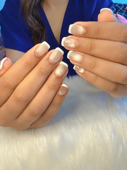 A full view of the cat eye French tip manicure, showing the subtle shimmer on each nail.