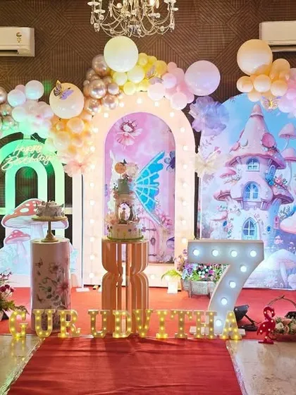Another view of the enchanted forest and butterfly themed party, highlighting the intricate details and lighting.