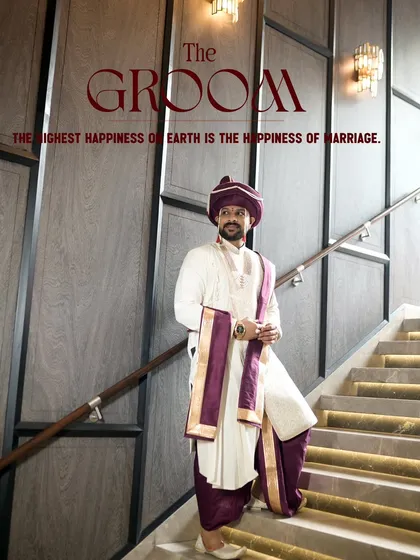 A stylish portrait of the groom, Akhil, in his traditional Maharashtrian attire. The modern setting of the staircase contrasts beautifully with his classic outfit, creating a powerful, regal image.