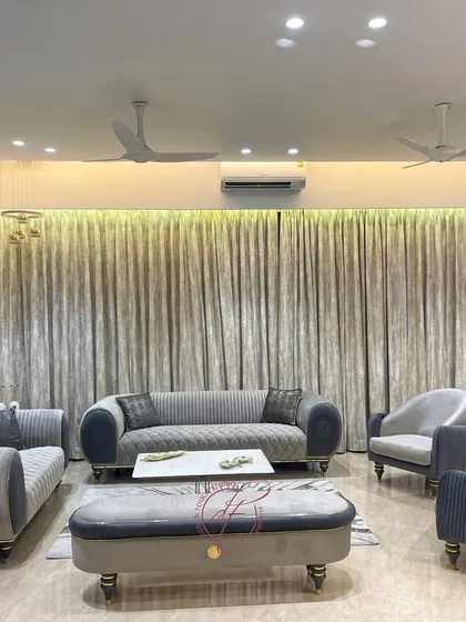 A closer look at the seating arrangement in the grey living room. The combination of different sofa styles and textures adds visual interest while maintaining a cohesive and calming atmosphere.