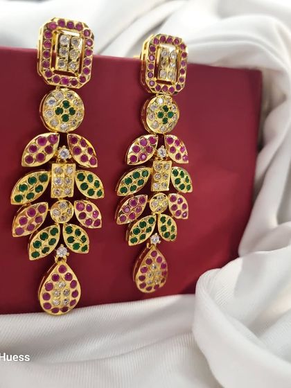 Another angle of the 'चारु' (Charu) earrings, highlighting their length and intricate design.