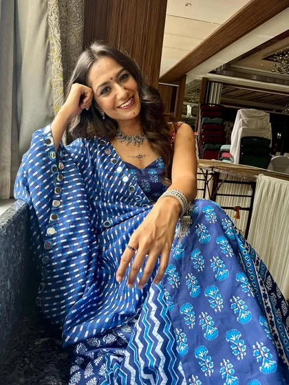 Relaxing before the Garba night begins. This shot showcases her radiant skin and the subtle details of her festive makeup.