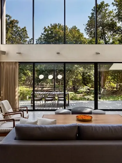 From inside, the floor-to-ceiling windows act as a living mural, constantly framing the dynamic beauty of the orchard. The interior design is kept minimal to ensure the focus remains on the view.