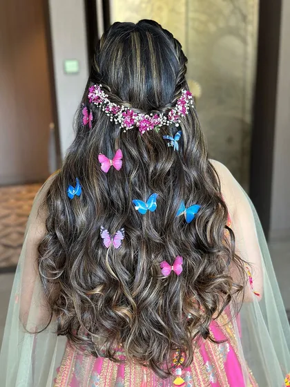 A detailed view of the butterfly and floral hair accessories, a look I love teaching for mehendi or carnival events.