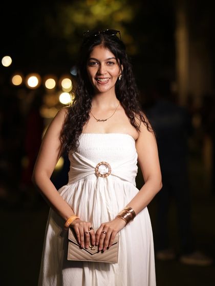 A front-facing shot of the white midi dress. The buckle detail adds a modern touch to this timeless piece.