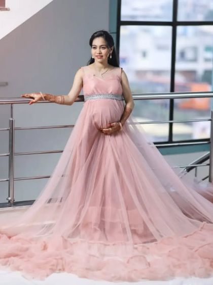My detachable long-tail gowns offer fairytale looks at an affordable rental price. This pink net gown is lightweight and easy to wear for your entire maternity shoot.