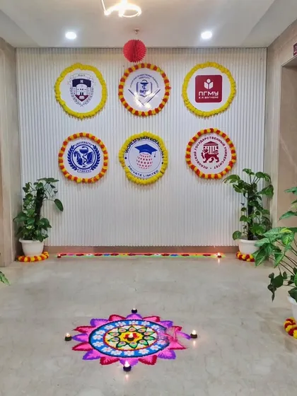 For Diwali, I create a festive and welcoming environment. Here you can see a beautiful rangoli at the entrance, complemented by custom company logos framed with marigold flowers to blend branding with tradition.