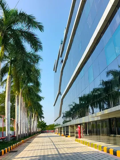 We specialize in large-scale commercial landscaping for corporate campuses and IT parks. This project at SIPCOT IT Park features a clean, modern design with royal palms lining the driveway, creating an impressive entrance for employees and visitors.