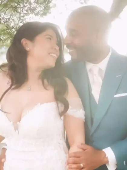 The soft glow of this photo captures an intimate wedding moment. The groom’s teal suit, with its impeccable tailoring, adds a touch of modern romance and personality to the celebration.